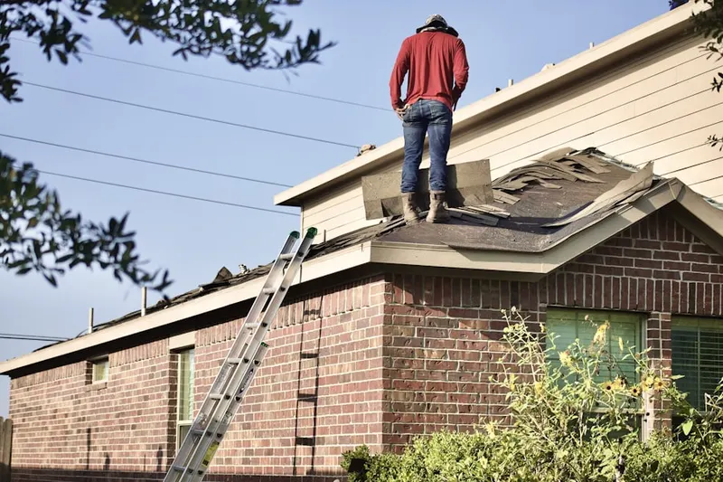 Professional roofer working on a residential roof in Brittany Farms